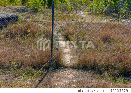 Hole in Wire Fence Hole in Wire Fence 143135579