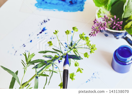 Paintbrush, blue ink and green plant for creating creative plant print Paintbrush, blue ink and green plant for creating creative plant print 143138070