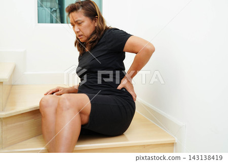 Asian lady fall down the stairs and pain at hip and waist because slippery surfaces. 143138419