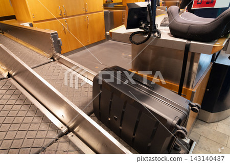 Luggage moving through airport baggage handling system 143140487