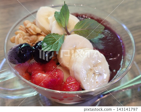 Yogurt topped with acai and blueberry sauce Yogurt topped with acai and blueberry sauce 143141797