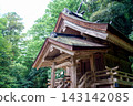 The gable roof overlaps with the wooden shrine buildings within the grounds of Izumo Taisha Shrine. 143142085