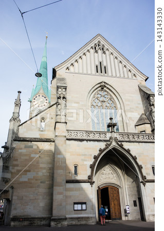 A historic church with a clock tower bathed in bright sunlight – the cityscape of Zurich, Switzerland. A historic church with a clock tower bathed in bright sunlight – the cityscape of Zurich, Switzerland. 143143330