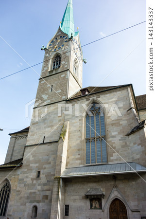 A historic church with a clock tower bathed in bright sunlight – the cityscape of Zurich, Switzerland. A historic church with a clock tower bathed in bright sunlight – the cityscape of Zurich, Switzerland. 143143337