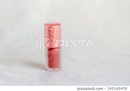 Bottle of red nail polish on a plain background Bottle of red nail polish on a plain background 143143470