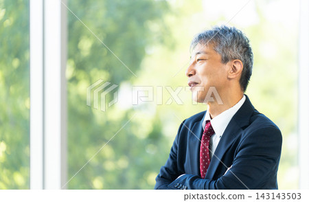 Senior male businessman with arms crossed Senior male businessman with arms crossed 143143503