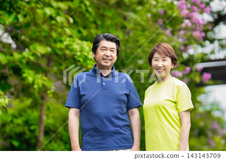 A senior couple smiling amidst the greenery A senior couple smiling amidst the greenery 143143709