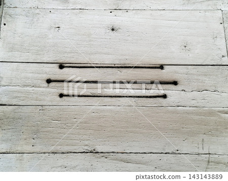 Three black horizontal burnt lines on weathered white painted wooden plank wall. Three black horizontal burnt lines on weathered white painted wooden plank wall. 143143889