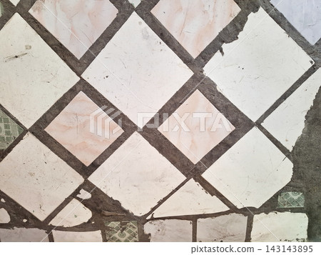 Old white and pink diamond patterned floor tiles with grunge texture. Old white and pink diamond patterned floor tiles with grunge texture. 143143895