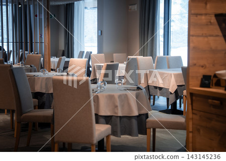 San Domenico ski resort dining room with round tables and gray linens San Domenico ski resort dining room with round tables and gray linens 143145236