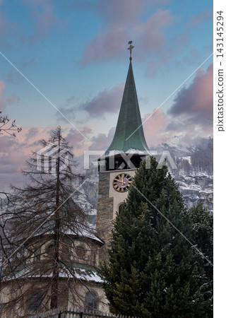 Parish Church of St. Mauritius steeple in snowy Zermatt, Switzerland Parish Church of St. Mauritius steeple in snowy Zermatt, Switzerland 143145294