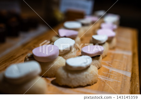 Dessert canapes on wooden board with pastel disks in the Maldives Dessert canapes on wooden board with pastel disks in the Maldives 143145359