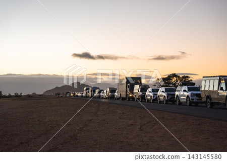 Safari vehicles waiting in line at sunrise in Namib Naukluft National Park Safari vehicles waiting in line at sunrise in Namib Naukluft National Park 143145580