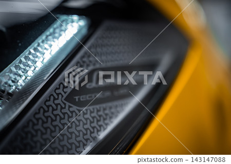 Extreme close up shows hexagonal elements and badge reading Lamborghini Tecnica LED. Soft indoor lighting highlights textures and crisp LED within tight framing. Extreme close up shows hexagonal elements and badge reading Lamborghini Tecnica LED. Soft indoor lighting highlights textures and crisp LED within tight framing. 143147088