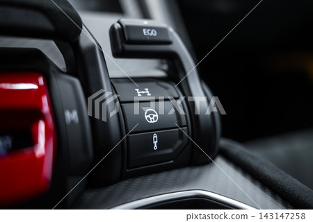 Close up of Lamborghini Urus Performante center console shows EGO switch, differential, steering, and suspension buttons on carbon fiber trim with soft studio lighting. Close up of Lamborghini Urus Performante center console shows EGO switch, differential, steering, and suspension buttons on carbon fiber trim with soft studio lighting. 143147258