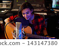 Portrait of a young female singer with guitar 143147380