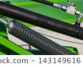 Black pistons or actuators in green pneumatic or hydraulic machine. Technology 143149616