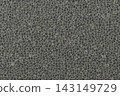 Grey volcanic stone texture background with rough pebble pattern and dark charcoal mineral surface details. 143149729