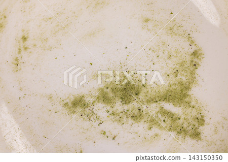 Green matcha powder residue creating abstract pattern Green matcha powder residue creating abstract pattern 143150350