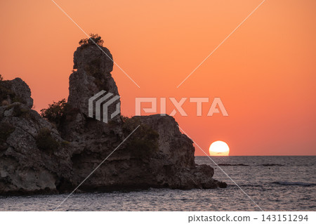 日落時的海岸線:天空和大海的壯麗景色,以及令人驚嘆的岩石地形。 日落時的海岸線:天空和大海的壯麗景色,以及令人驚嘆的岩石地形。 143151294