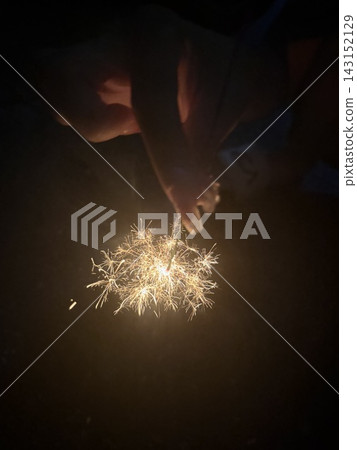 Enjoying sparklers glowing in the darkness on a summer night 4 Enjoying sparklers glowing in the darkness on a summer night 4 143152129