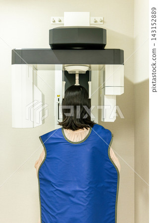 A woman getting an X-ray at a dental clinic A woman getting an X-ray at a dental clinic 143152889
