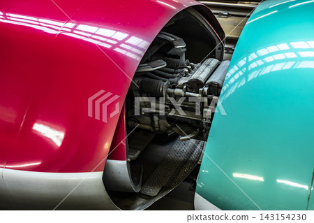 A photo of the coupling section of a Shinkansen train taken from an oblique angle. A photo of the coupling section of a Shinkansen train taken from an oblique angle. 143154230