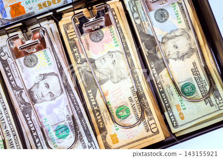 Different dollar banknotes are visible inside an open cash register 143155921