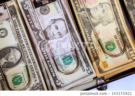 American dollar cash banknotes are arranged inside cashier drawer. American dollar cash banknotes are arranged inside cashier drawer. 143155922