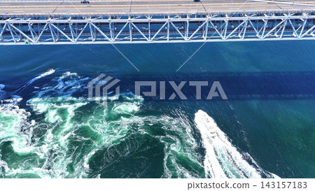 A breathtaking view of the magnificent whirlpools in the Naruto Strait, captured from directly above. A breathtaking view of the magnificent whirlpools in the Naruto Strait, captured from directly above. 143157183