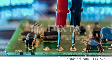 Red and Black Test Probes Measuring Electronic Components on Printed Circuit Board for Maintenance and Troubleshooting Red and Black Test Probes Measuring Electronic Components on Printed Circuit Board for Maintenance and Troubleshooting 143157428