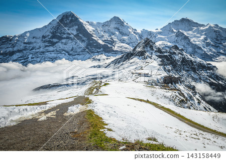 Famous snowy mountain peaks over misty valleys, Lauterbrunnen, Switzerland Famous snowy mountain peaks over misty valleys, Lauterbrunnen, Switzerland 143158449