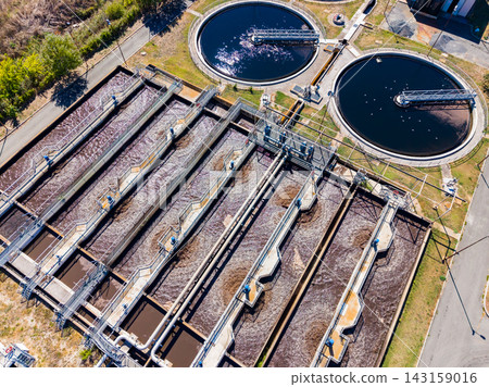 Water treatment facility with large tanks and filtration systems in operation during daylight hours Water treatment facility with large tanks and filtration systems in operation during daylight hours 143159016