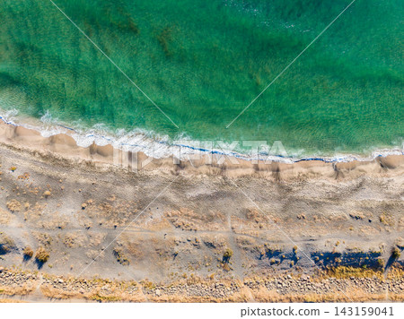 Coastline view of sandy beach and clear water during daytime under sunny sky Coastline view of sandy beach and clear water during daytime under sunny sky 143159041