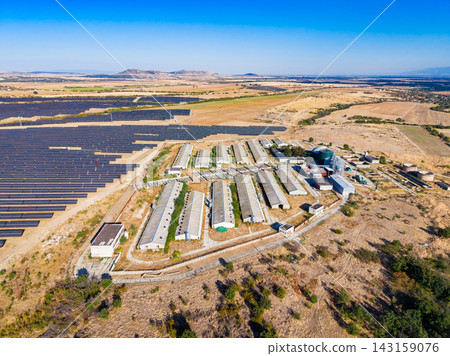 Farm layout with solar panels in a rural area under a clear sky showing agricultural land Farm layout with solar panels in a rural area under a clear sky showing agricultural land 143159076