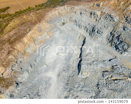 Granite quarry site showing extraction area and surrounding landscape with machinery and rock formations 143159079