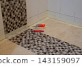Bathroom Tile Repair Preparation with Masking Tape and Hand Tools 143159097