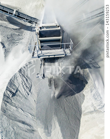Granite quarry operation shows large machinery working to extract stone and distribute material in an industrial setting Granite quarry operation shows large machinery working to extract stone and distribute material in an industrial setting 143159253