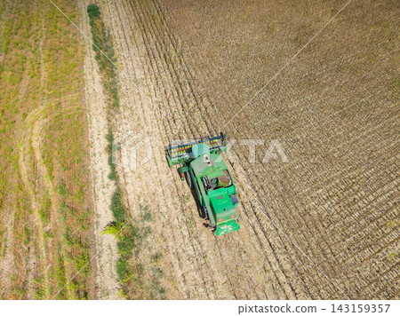 Tractor working in a cornfield during harvest time in North America Tractor working in a cornfield during harvest time in North America 143159357