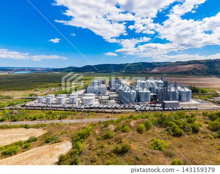 Industrial site with grain silos and storage facility in a rural area during the day Industrial site with grain silos and storage facility in a rural area during the day 143159379