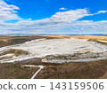 Quarry viewed from above shows the large excavation site surrounded by land and sky on a clear day 143159506