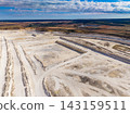 Quarry in an open landscape with bright sky and clear visibility of operations and terrain 143159511