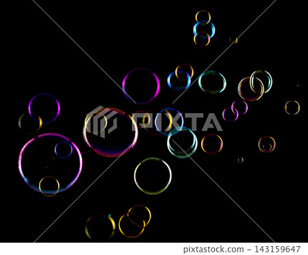 Soap Bubbles floating over black background isolated. Rainbow colorful air balls fly over many sizes. Shampoo bubbles sphere form shiny glossy blowing transparent purity in group. Soap Bubbles floating over black background isolated. Rainbow colorful air balls fly over many sizes. Shampoo bubbles sphere form shiny glossy blowing transparent purity in group. 143159647