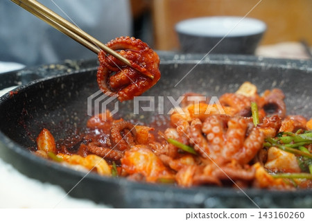 Picking Up Spicy Stir-Fried Webfoot Octopus with Chopsticks, Authentic Korean Seafood Dish (Jjukkumi-bokkeum) Picking Up Spicy Stir-Fried Webfoot Octopus with Chopsticks, Authentic Korean Seafood Dish (Jjukkumi-bokkeum) 143160260