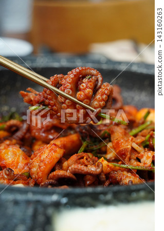 Picking Up Spicy Stir-Fried Webfoot Octopus with Chopsticks, Authentic Korean Seafood Dish (Jjukkumi-bokkeum) Picking Up Spicy Stir-Fried Webfoot Octopus with Chopsticks, Authentic Korean Seafood Dish (Jjukkumi-bokkeum) 143160263