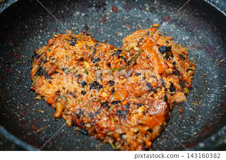 Heart-Shaped Korean Fried Rice with Seaweed Flakes served on an Iron Griddle Heart-Shaped Korean Fried Rice with Seaweed Flakes served on an Iron Griddle 143160382