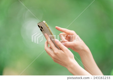 A woman who operates a smartphone A woman who operates a smartphone 143161233