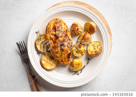 Oven roasted lemon garlic chicken and potatoes on plate Oven roasted lemon garlic chicken and potatoes on plate 143163016