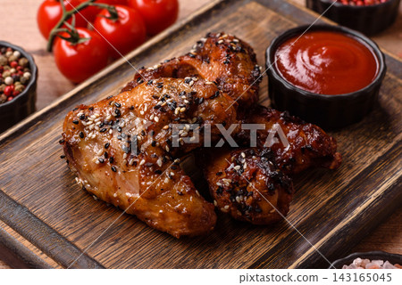 Grilled chicken wings with teriyaki sauce, seasoned with salt and spices. Chicken wings Grilled chicken wings with teriyaki sauce, seasoned with salt and spices. Chicken wings 143165045