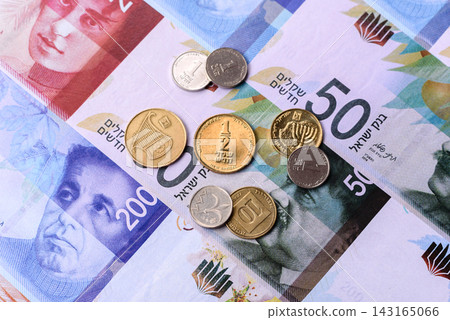 Israel, Israeli paper money, shekel banknotes and agorot coins as currency for exchange Israel, Israeli paper money, shekel banknotes and agorot coins as currency for exchange 143165066